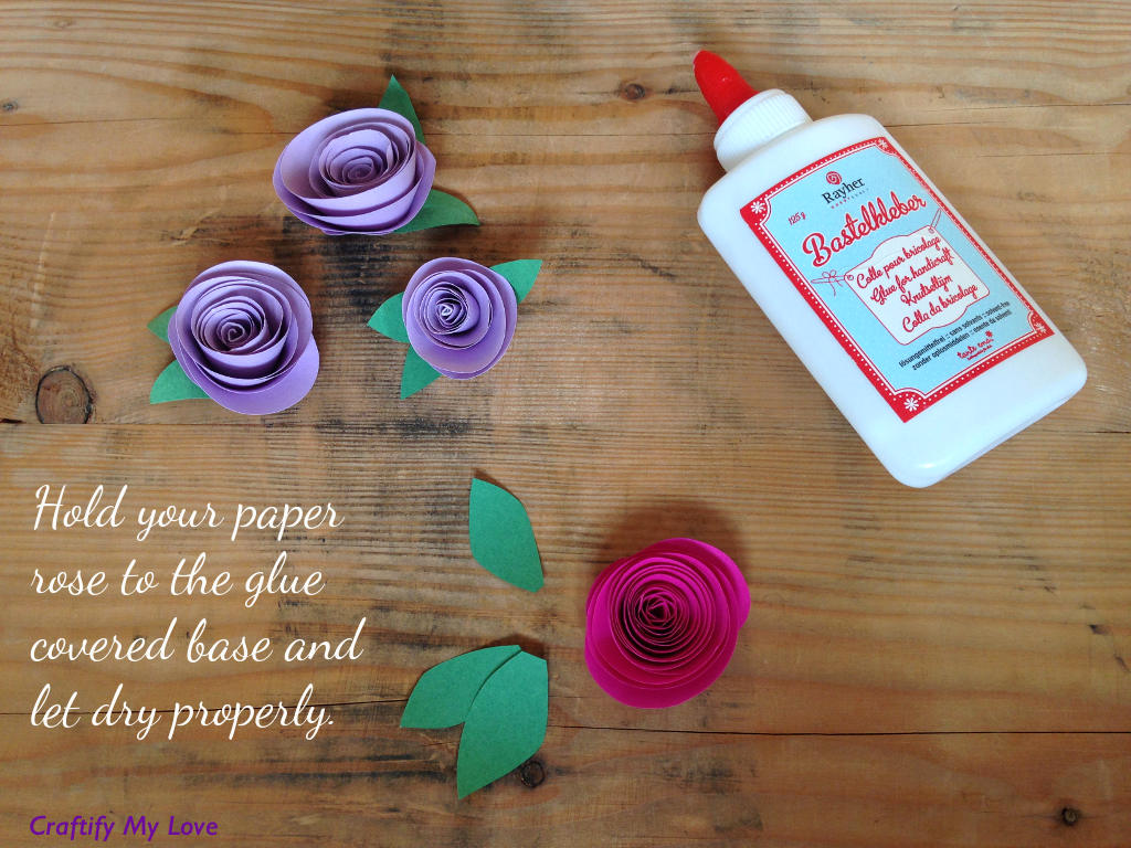 This image shows how to make paper roses - step 3: press the rose carefully on the glue and let dry properly.