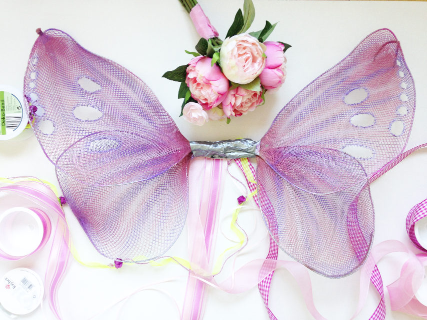 decorating handmade butterfly or fairy wings with ribbon and silk flowers