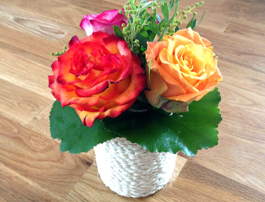 center piece with roses in an upcycled rope vase.