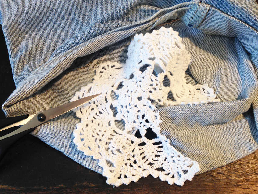 After sewing lace in place, cutting off excess material.