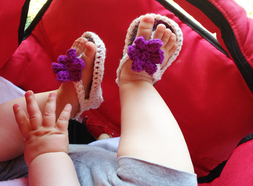 handmade crocheted baby flip flops with a flower