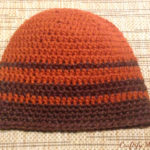 Crocheted men's hat in brown and rust stripes.