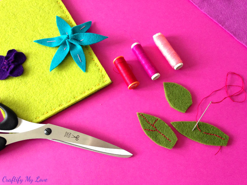 hand stitching contrasting details on felt leaves