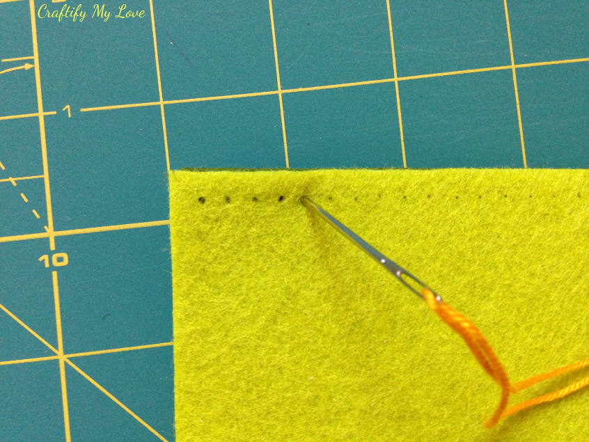 prepunching the holes for your stitches to diy felt tablet sleeve