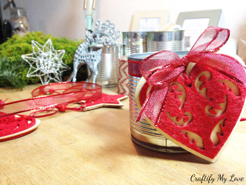 adding Christmas ornaments to upcycled tin can advent wreath