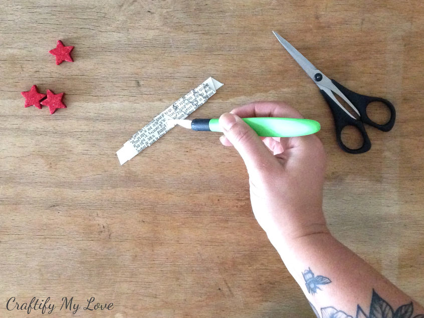 cutting a hole to insert the trunk to your paper christmas tree