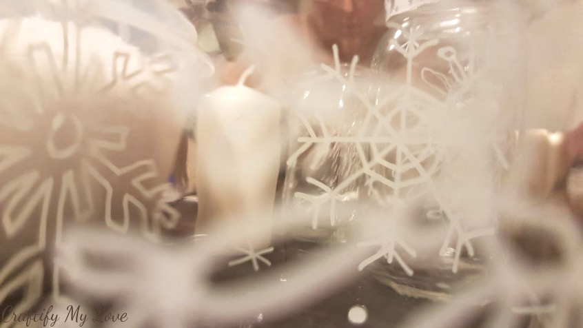 hand drawn snowflakes on empty jar candle holders