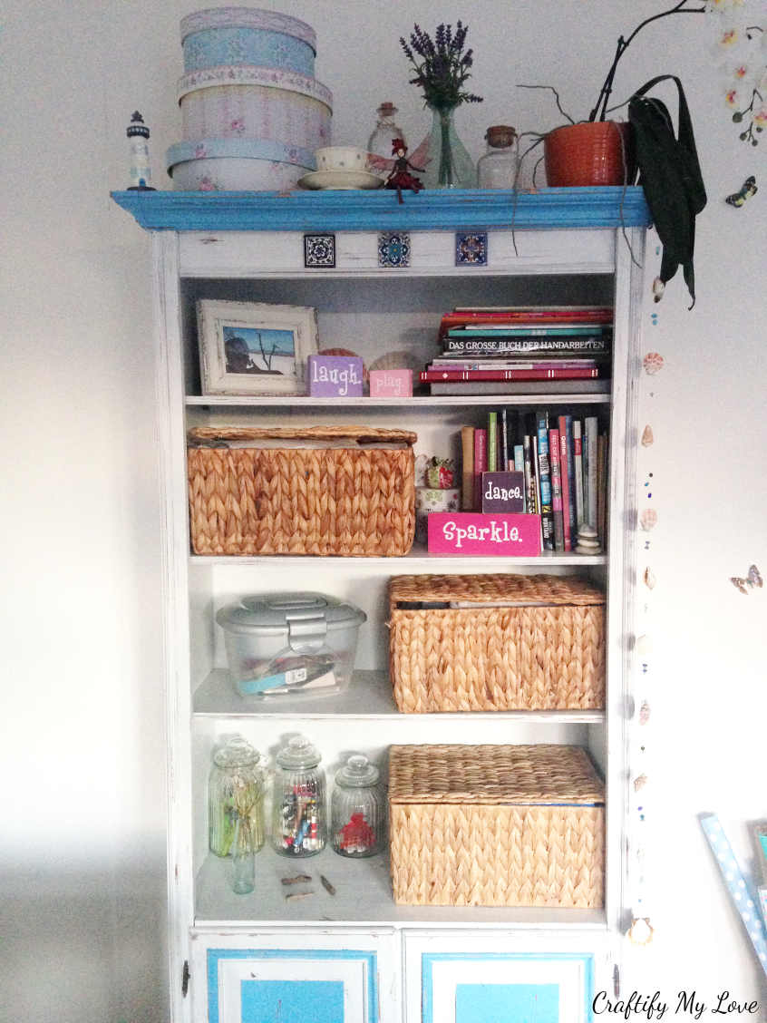 decluttered bookshelf after purging for the craft room challenge