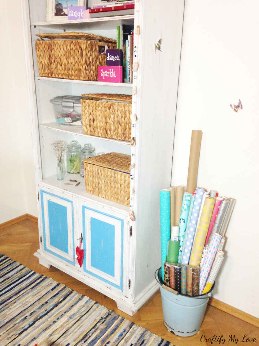 decluttering a shelving solution in my craft room and wrapping paper storage hack using a basket