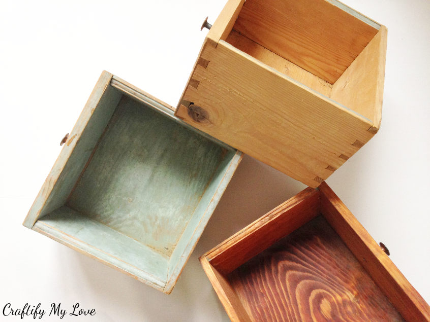 DIY recycling project inclding three old drawers turned into storage space shelf