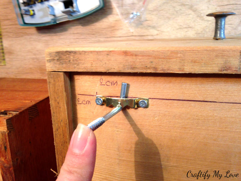 hanging upcycled drawers on hooks to the wall for a DIY shelving decor