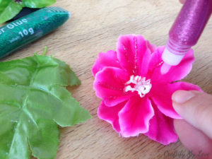 adding glitter glue to feaux flowers