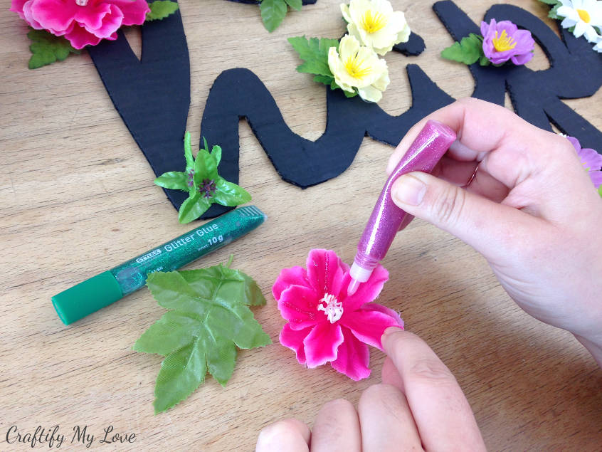 adding sparkly glitter glue to spring craft project