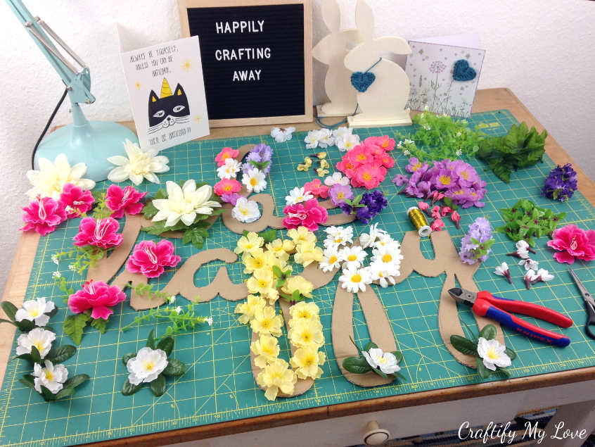 arrange flowers on your motivational cut-out cardboard sign until you're happy with the design