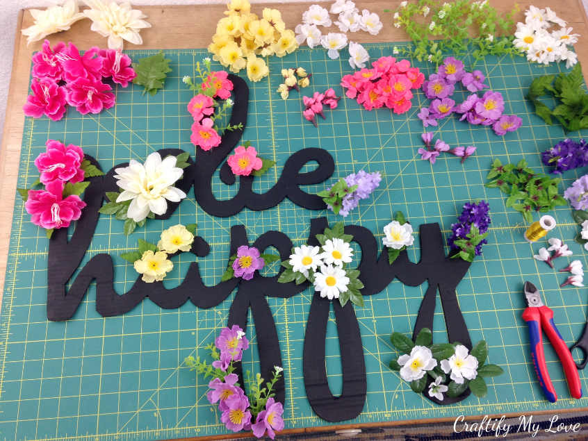 arrange the silk flowers on your motivational sign 