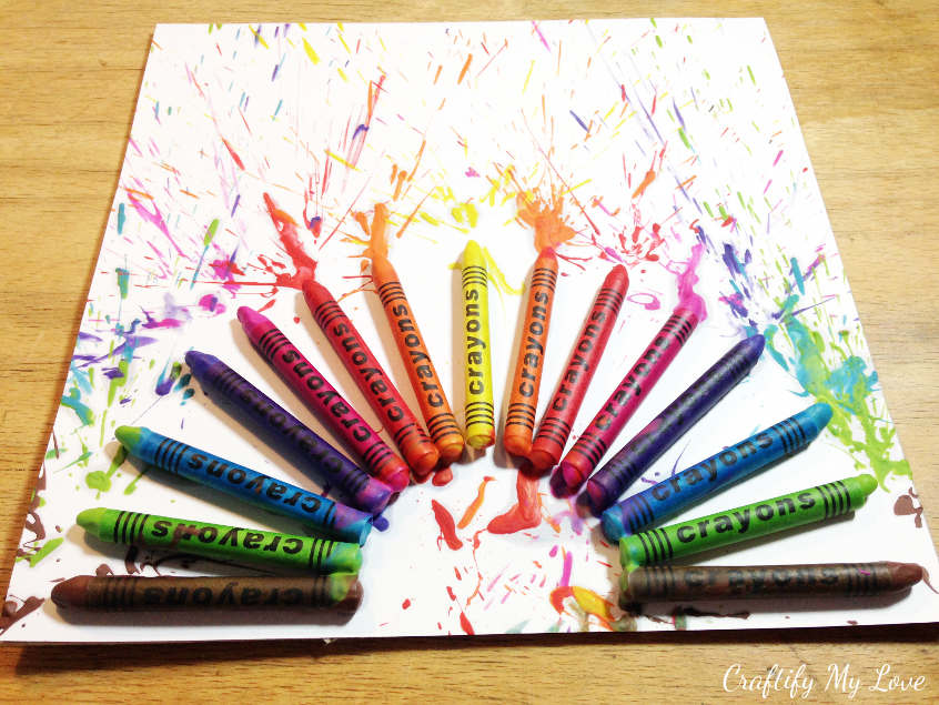 gluing crayons on cardstock for rainbow fireworks. Paint splatter inspired home decor