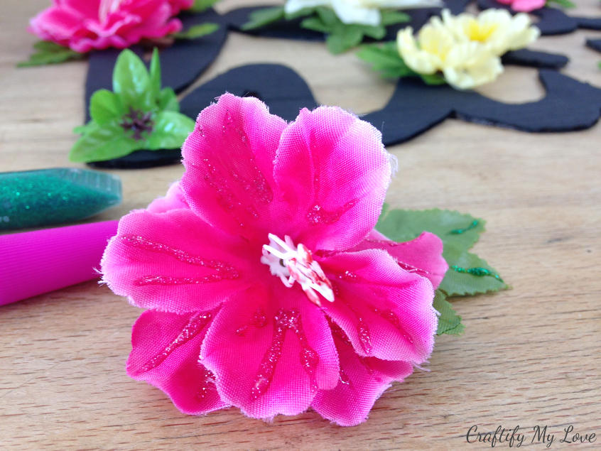 silk flowers decorated with glitter glue for bling on the crafts blog hop spring