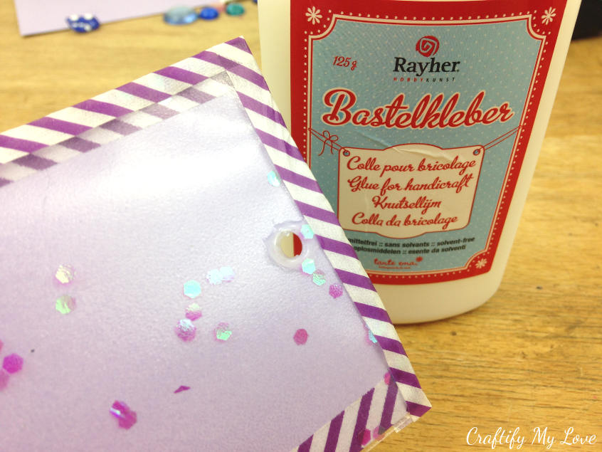add glue to prevent glitter falling out of your diy bookmark from tickets