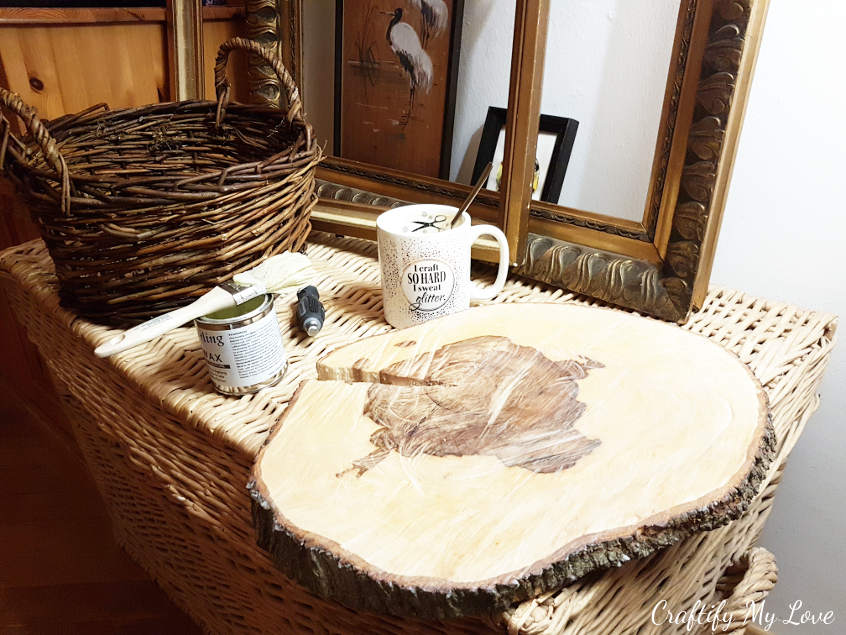 apply an even coat of clear wood wax to sanded tree slice to seal the surface and let it dry