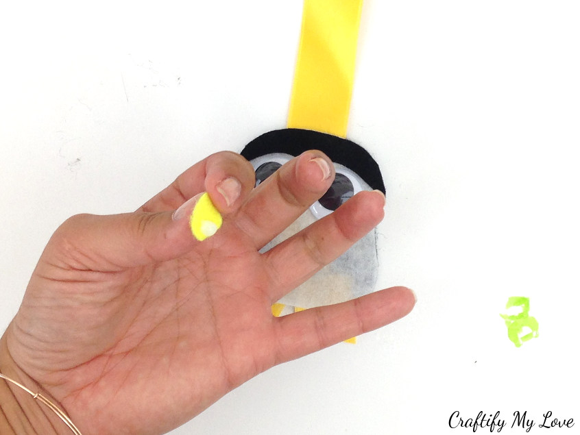 using craft glue or spray adhesive attach the beak to fun arts and craft kids bird bookmark
