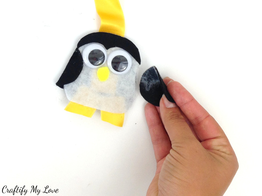 using spray adhesive glue the felt circle wing to your layering penguin owl bookmark