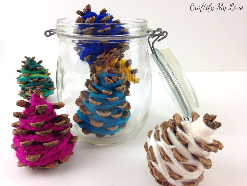 Christmas trees in a jar: Frugal home decor nature craft using pine cones and happy colourful yarn leftovers