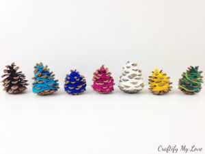 colourful pine cone yarn Christmas trees that are a frugal home decor that you can craft with your kids