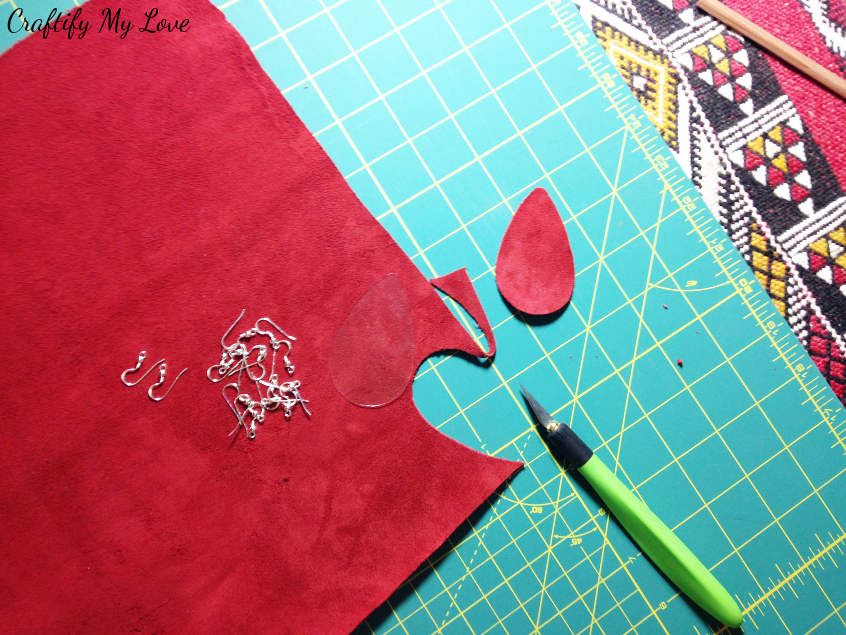 Cut out the teardrop shape from red velvet using an x-acto knife to DIY earrings