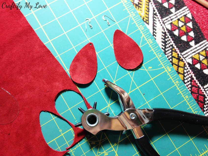 Make a hole in each of your red velvet suede earrings using a leather hole punch.