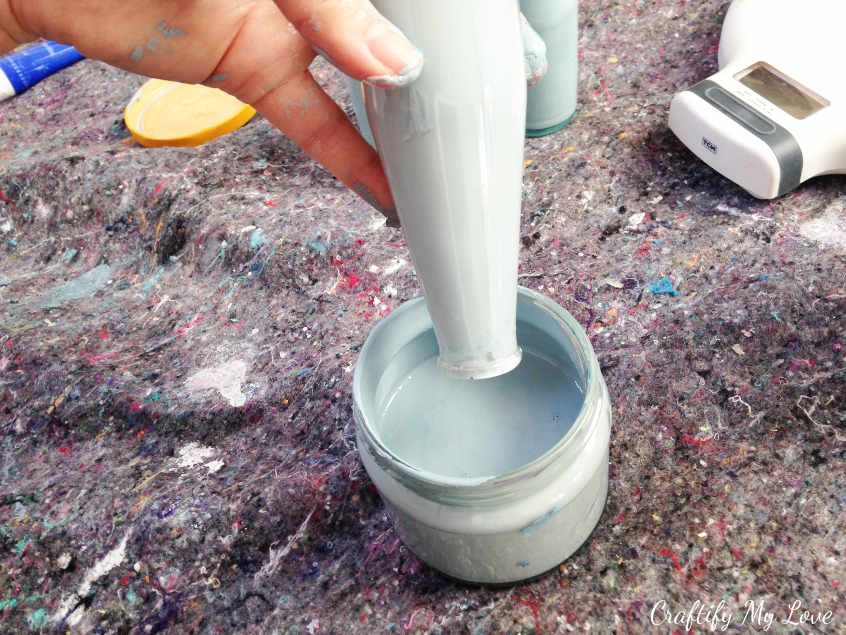 Let any excess paint drip out of your recycled bottle to DIY cute little colourful vases